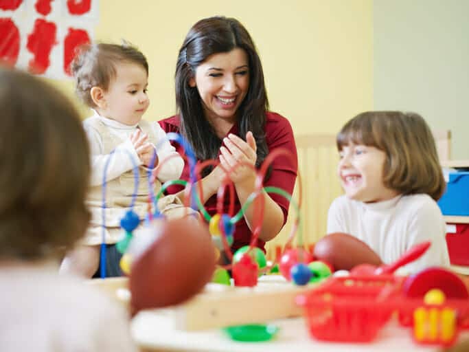 kids laughing with early child card assistant