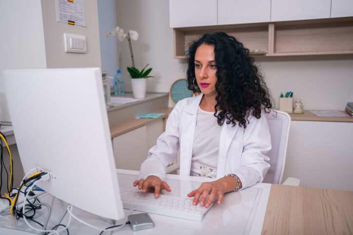 medical office administrator program working on a computer