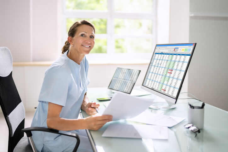 A Medical Office Administrator organizing patient medical billing codes, demonstrating one of the many duties of a Medical Office Administrator